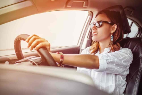 Woman Driving in the Sun with Sunglasses On